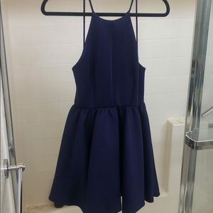 Navy blue dress with low cut back.